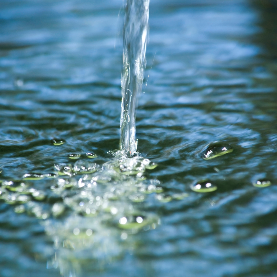 Image of a stream of water pouring into a unit of water