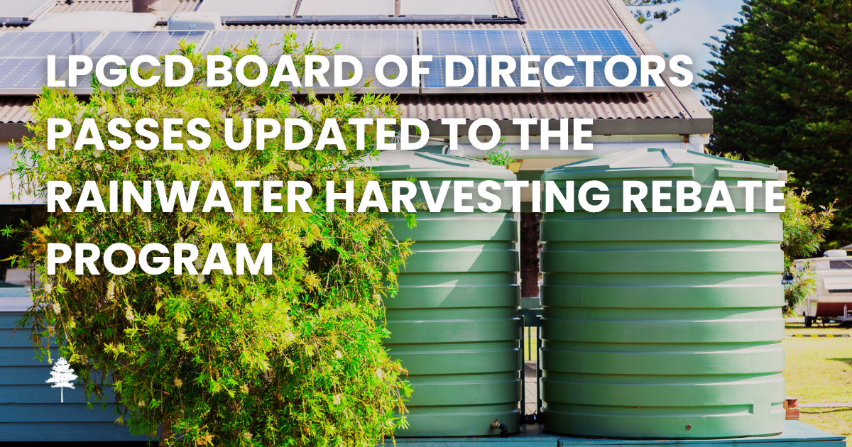 Two green rainwater storage tanks beside a home with text announcing updates to the LPGCD RWH Progra