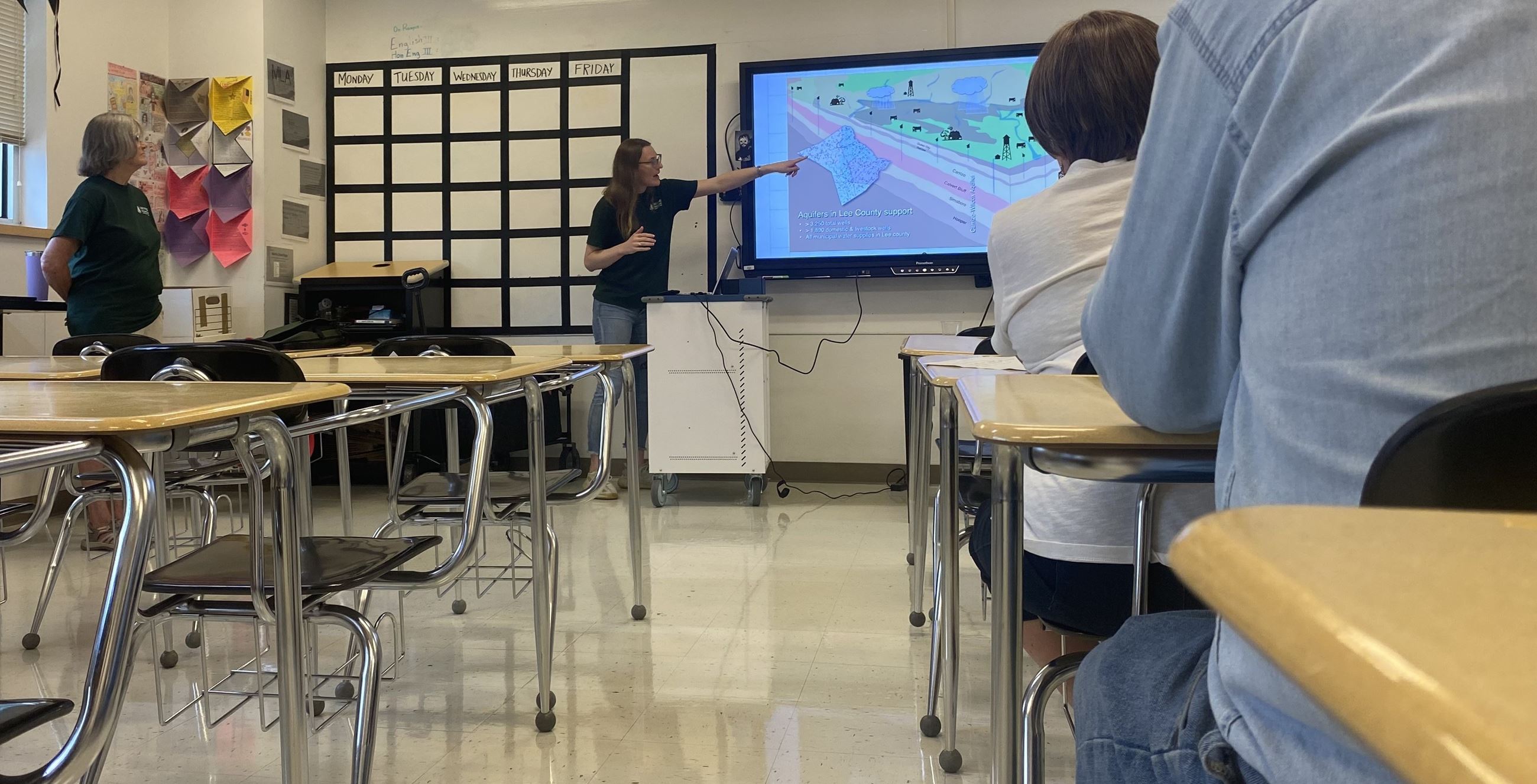Image of people sitting in classroom watching presentation