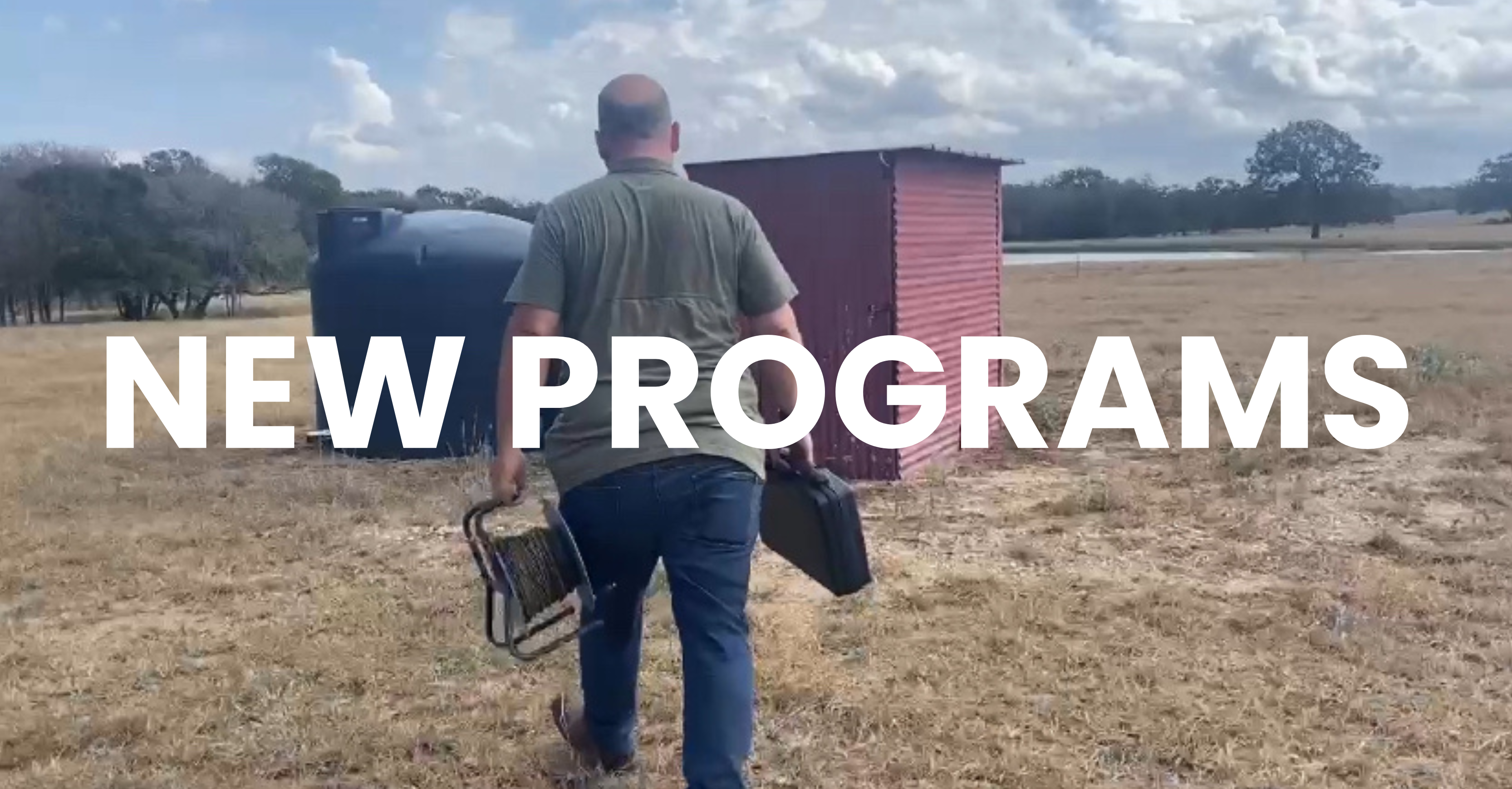 Man walking in a field toward a shed and water tank, carrying equipment. Large text reads “NEW PROGR